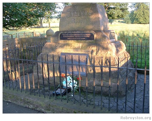 Robroyston Wallace Monument base with flowers and memorial stone